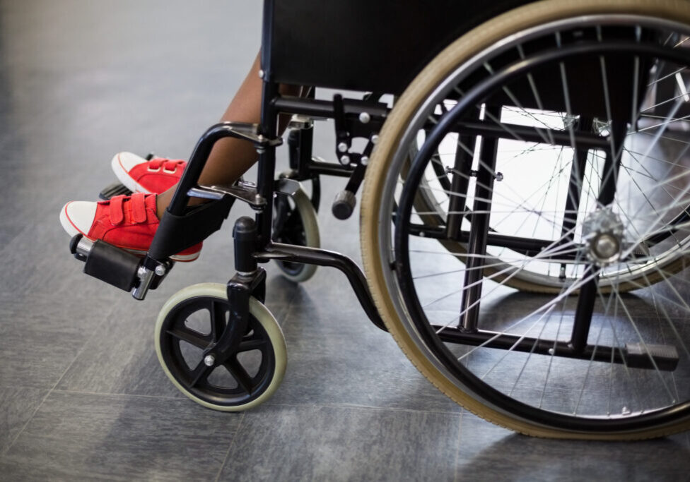 Boy sitting on wheelchair at school