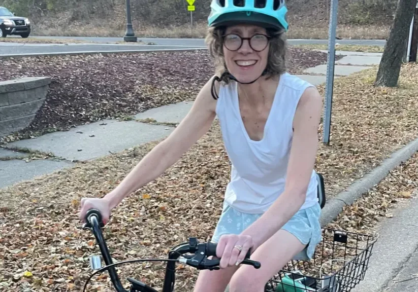 Woman wearing a helmut riding an electric bike