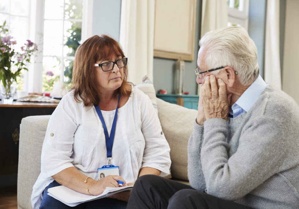 Support Worker Visits Senior Man Suffering With Depression